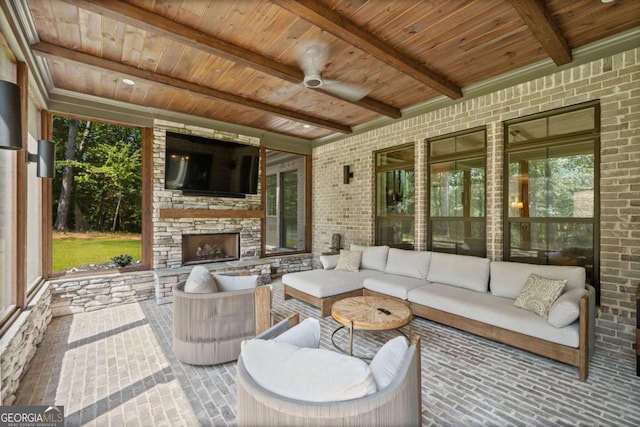 view of patio with an outdoor living space with a fireplace