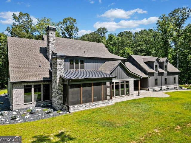 back of house featuring a chimney, board and batten siding, a standing seam roof, a shingled roof, and a sunroom