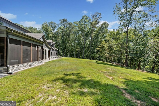 view of yard featuring a sunroom