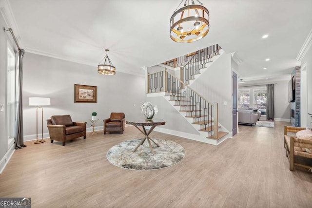 foyer featuring crown molding, stairway, a chandelier, and baseboards