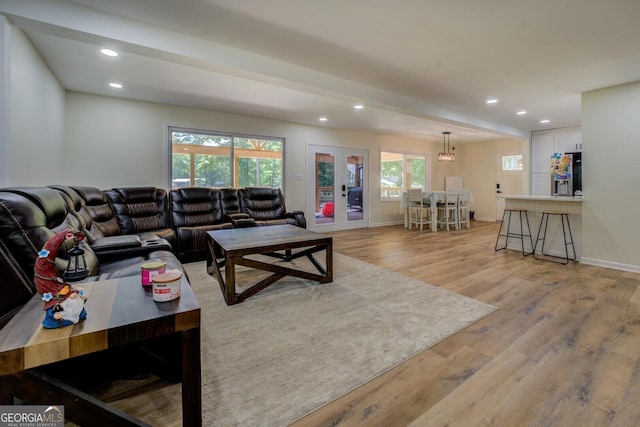 living area featuring light wood-style floors, baseboards, french doors, and recessed lighting