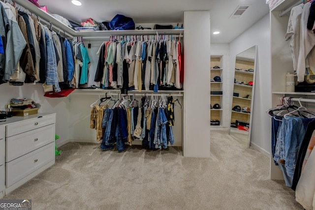 walk in closet with light carpet and visible vents