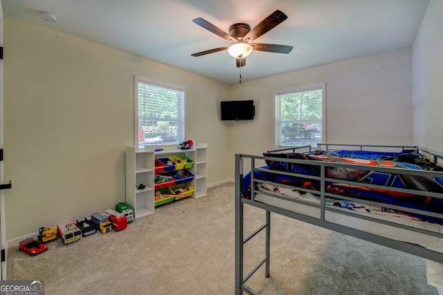 bedroom featuring carpet floors, multiple windows, baseboards, and ceiling fan