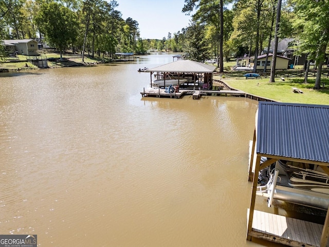 dock area with boat lift and a water view