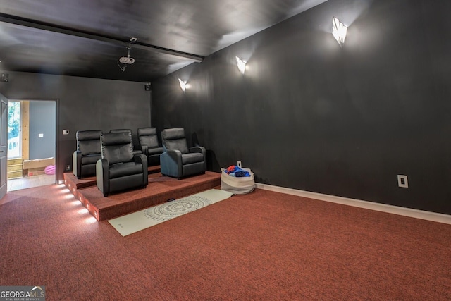 carpeted cinema room with baseboards