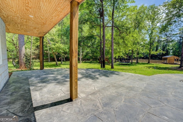 view of patio featuring a storage unit and an outbuilding