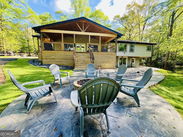 view of patio / terrace with a ceiling fan and an outdoor fire pit