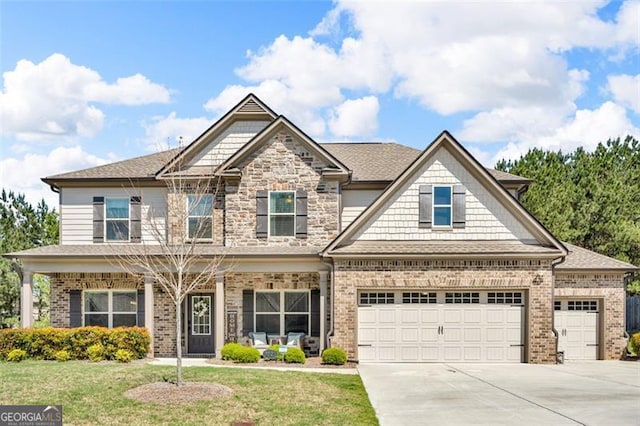 craftsman-style home featuring brick siding, roof with shingles, a front lawn, and concrete driveway