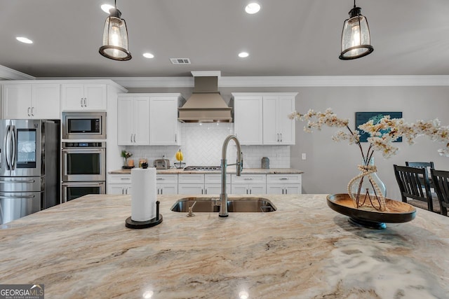 kitchen featuring visible vents, a sink, light stone countertops, custom range hood, and stainless steel appliances