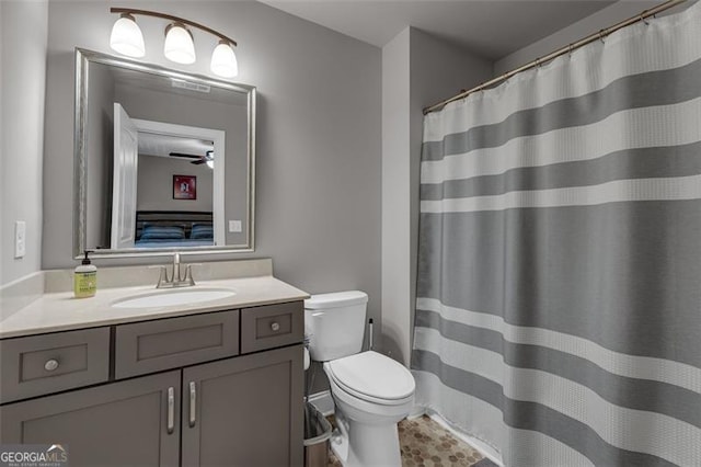 full bath with toilet, connected bathroom, and vanity