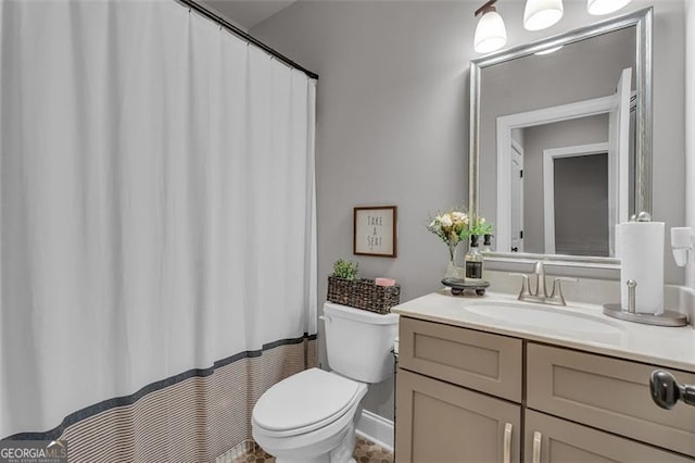 full bathroom featuring toilet, vanity, and a shower with shower curtain