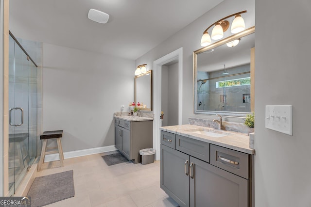 bathroom with a sink, two vanities, and a shower stall