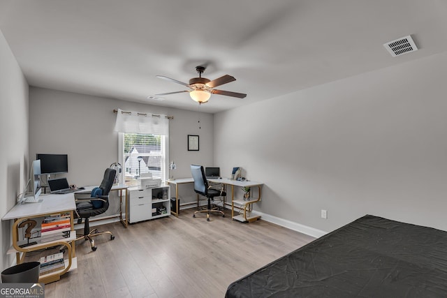 office with visible vents, baseboards, a ceiling fan, and wood finished floors