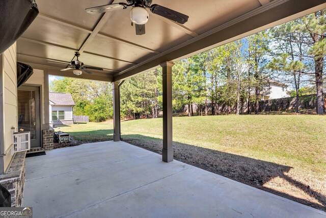 view of patio with ceiling fan and fence