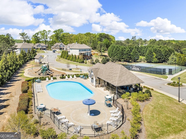 community pool featuring a patio area and fence
