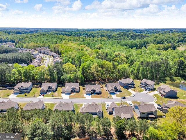 birds eye view of property with a wooded view and a residential view