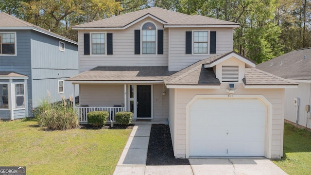 traditional home with a shingled roof, an attached garage, covered porch, a front lawn, and driveway