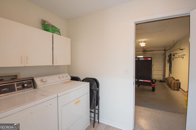 clothes washing area featuring cabinet space, baseboards, and separate washer and dryer