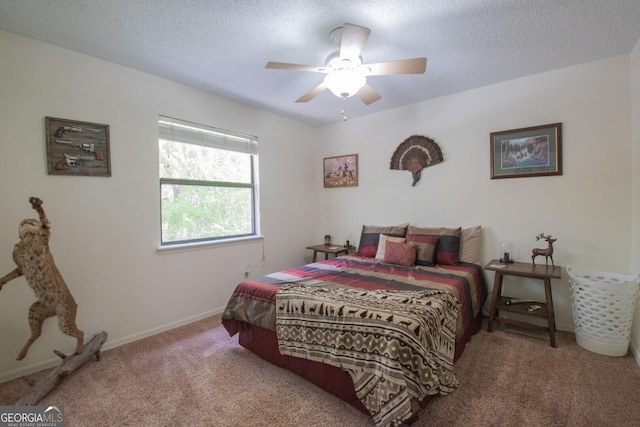 carpeted bedroom featuring baseboards, a ceiling fan, and a textured ceiling