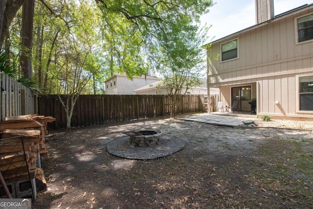 view of yard featuring a patio, a fenced backyard, and an outdoor fire pit