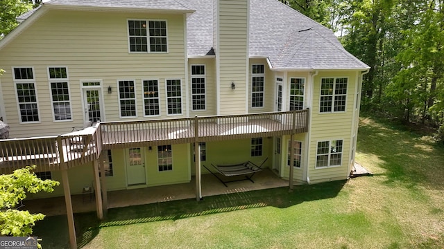 150 Fauna Meadows Dr, Newnan, GA 30263 - rear view of house with a shingled roof, a patio, a deck, and a lawn