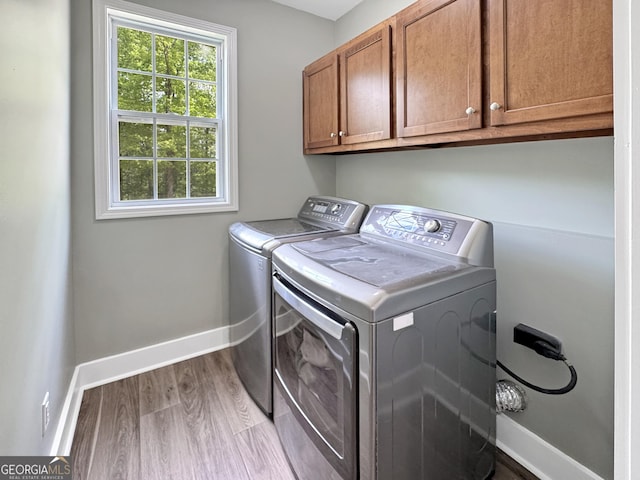 150 Fauna Meadows Dr, Newnan, GA 30263 - laundry area with cabinet space, separate washer and dryer, and wood finished floors