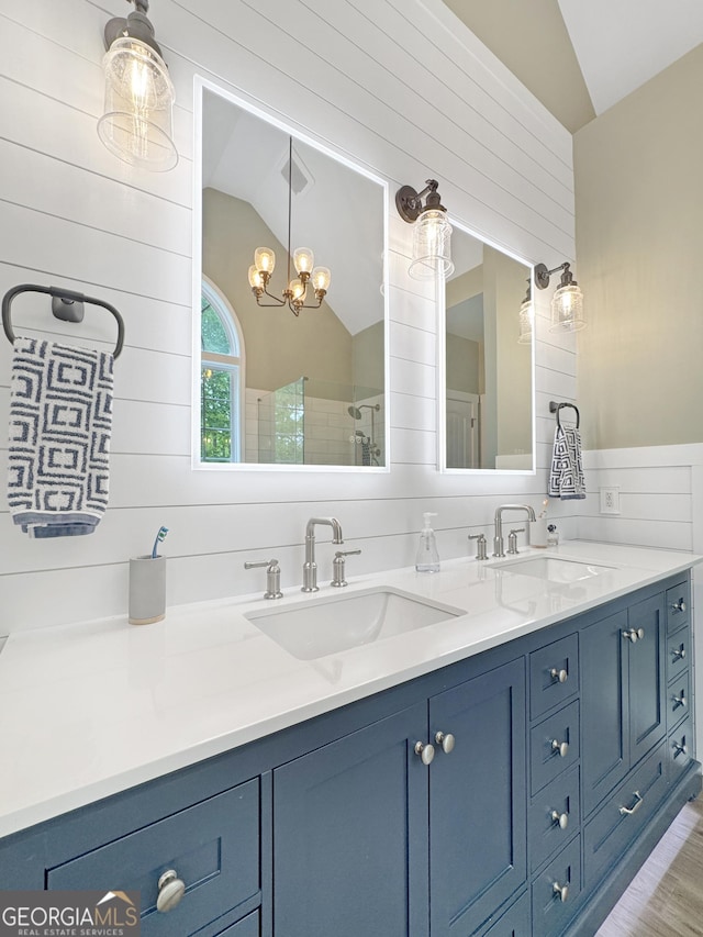 150 Fauna Meadows Dr, Newnan, GA 30263 - bathroom featuring vaulted ceiling, double vanity, tiled shower, and a chandelier