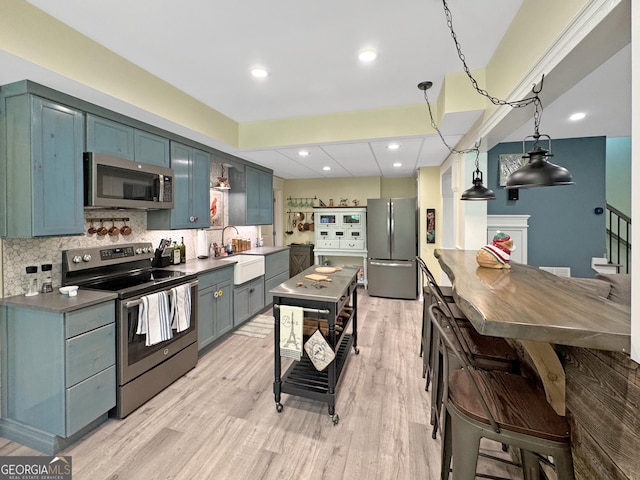 150 Fauna Meadows Dr, Newnan, GA 30263 - kitchen featuring appliances with stainless steel finishes, light wood finished floors, tasteful backsplash, and recessed lighting