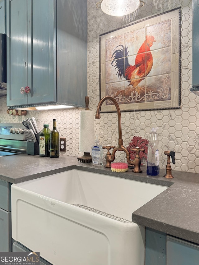 150 Fauna Meadows Dr, Newnan, GA 30263 - kitchen with decorative backsplash, dark countertops, range, and blue cabinets