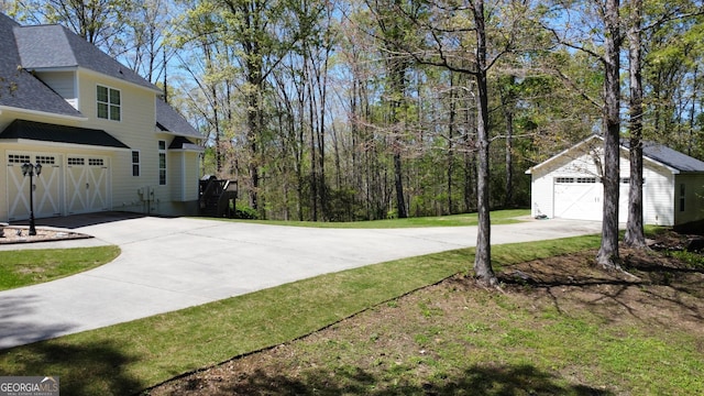 150 Fauna Meadows Dr, Newnan, GA 30263 - view of grassy yard featuring a garage, driveway, and an outbuilding