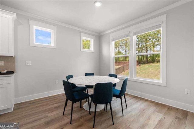 4038 Andover Cir, Mcdonough, GA 30252 - dining space featuring light wood-type flooring, baseboards, and ornamental molding