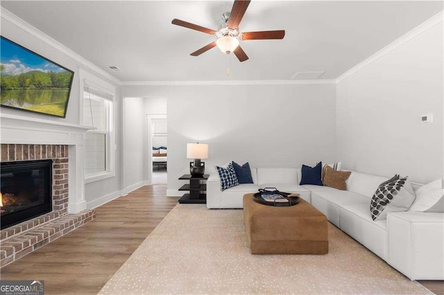 4038 Andover Cir, Mcdonough, GA 30252 - living area with visible vents, a ceiling fan, a fireplace, crown molding, and wood finished floors