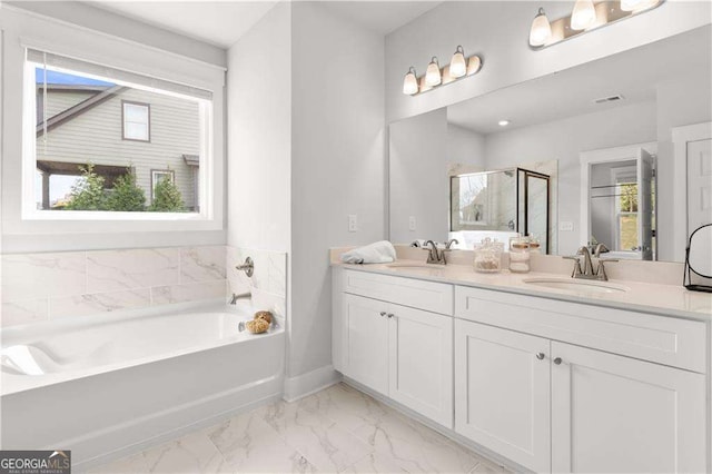 4038 Andover Cir, Mcdonough, GA 30252 - bathroom with double vanity, a bath, marble finish floor, and a sink