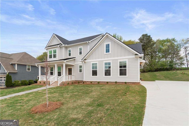 4038 Andover Cir, Mcdonough, GA 30252 - craftsman house featuring board and batten siding, a front yard, and a porch