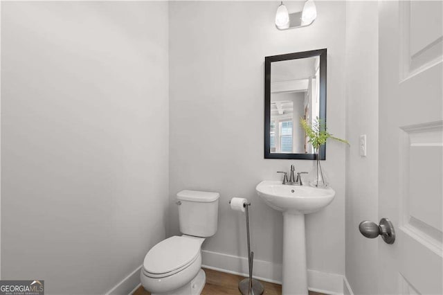 4038 Andover Cir, Mcdonough, GA 30252 - half bath featuring toilet, a sink, and baseboards
