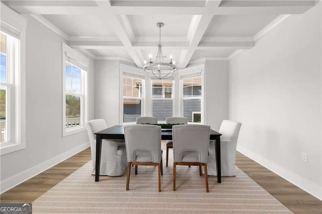 4038 Andover Cir, Mcdonough, GA 30252 - dining space with wood finished floors, an inviting chandelier, and baseboards