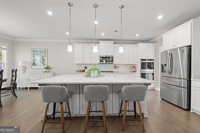 3087 Mountain Shadow Way, Marietta, GA 30064 - kitchen with decorative backsplash, appliances with stainless steel finishes, crown molding, and a center island with sink