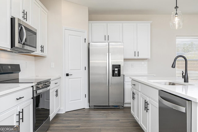 383 Cantrell Dr, Dallas, GA 30157 - kitchen with a sink, dark wood-style flooring, decorative backsplash, white cabinets, and appliances with stainless steel finishes