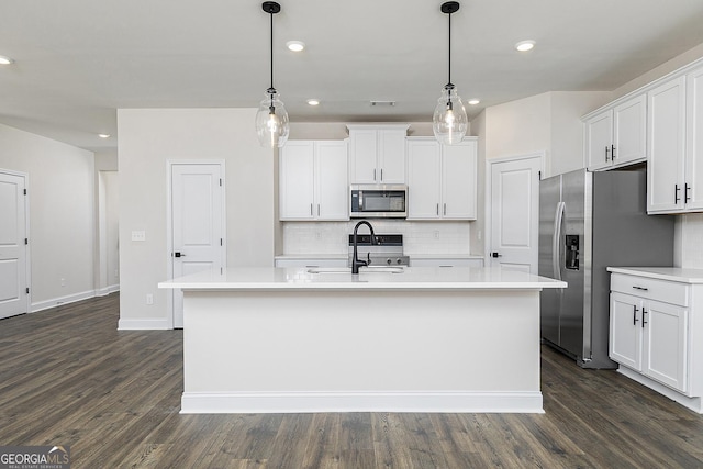383 Cantrell Dr, Dallas, GA 30157 - kitchen with a kitchen island with sink, stainless steel appliances, light countertops, backsplash, and a sink