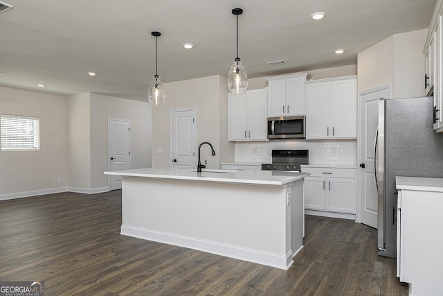 383 Cantrell Dr, Dallas, GA 30157 - kitchen featuring dark wood-style floors, tasteful backsplash, stainless steel appliances, and white cabinetry