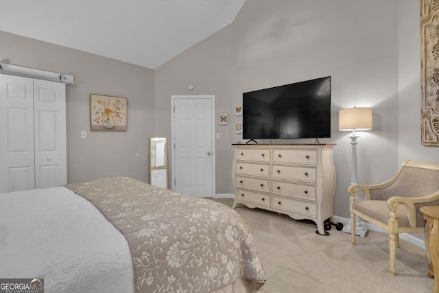 bedroom with a closet, high vaulted ceiling, baseboards, and carpet floors
