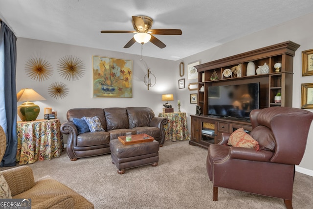 living room featuring ceiling fan and carpet