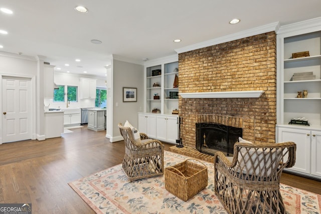 8925 Huntcliff Lake Ct, Atlanta, GA 30350 - living area with dark wood-style flooring, recessed lighting, ornamental molding, and a fireplace