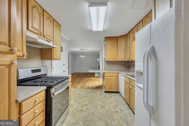 4164 Weston Dr, Powder Springs, GA 30127 - kitchen featuring white appliances, under cabinet range hood, ornamental molding, light countertops, and backsplash