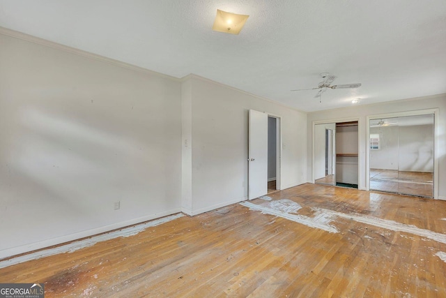 4164 Weston Dr, Powder Springs, GA 30127 - unfurnished bedroom with hardwood / wood-style floors, multiple closets, ornamental molding, baseboards, and ceiling fan