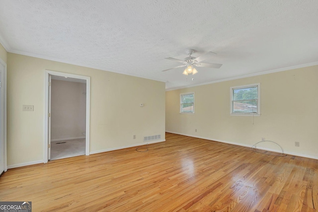 4164 Weston Dr, Powder Springs, GA 30127 - empty room with light wood finished floors, a ceiling fan, crown molding, a textured ceiling, and baseboards