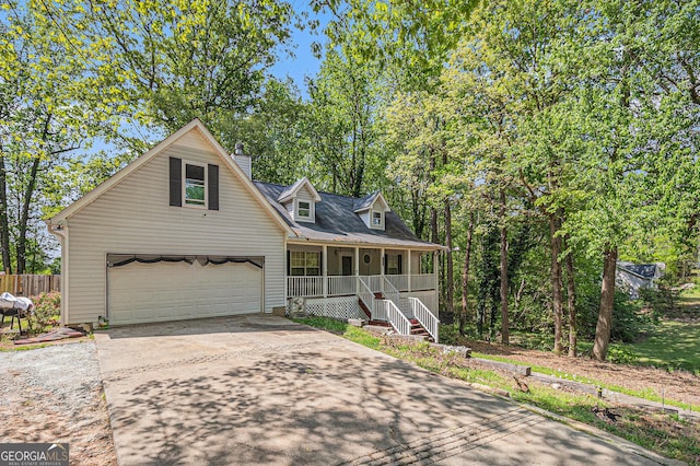 view of front facade featuring a porch, an attached garage, and driveway