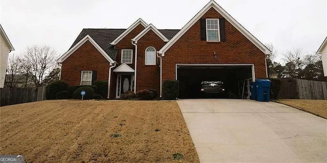 traditional home with a garage, a front lawn, fence, brick siding, and concrete driveway