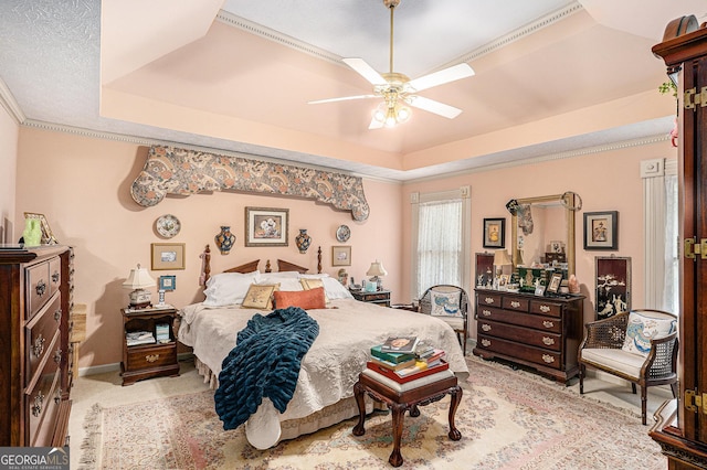 110 Emerald Dr, Mcdonough, GA 30253 - carpeted bedroom featuring a tray ceiling, ornamental molding, baseboards, and a ceiling fan