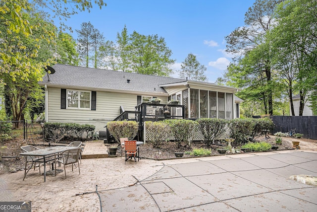 110 Emerald Dr, Mcdonough, GA 30253 - back of house featuring a shingled roof, fence, a patio, and a sunroom
